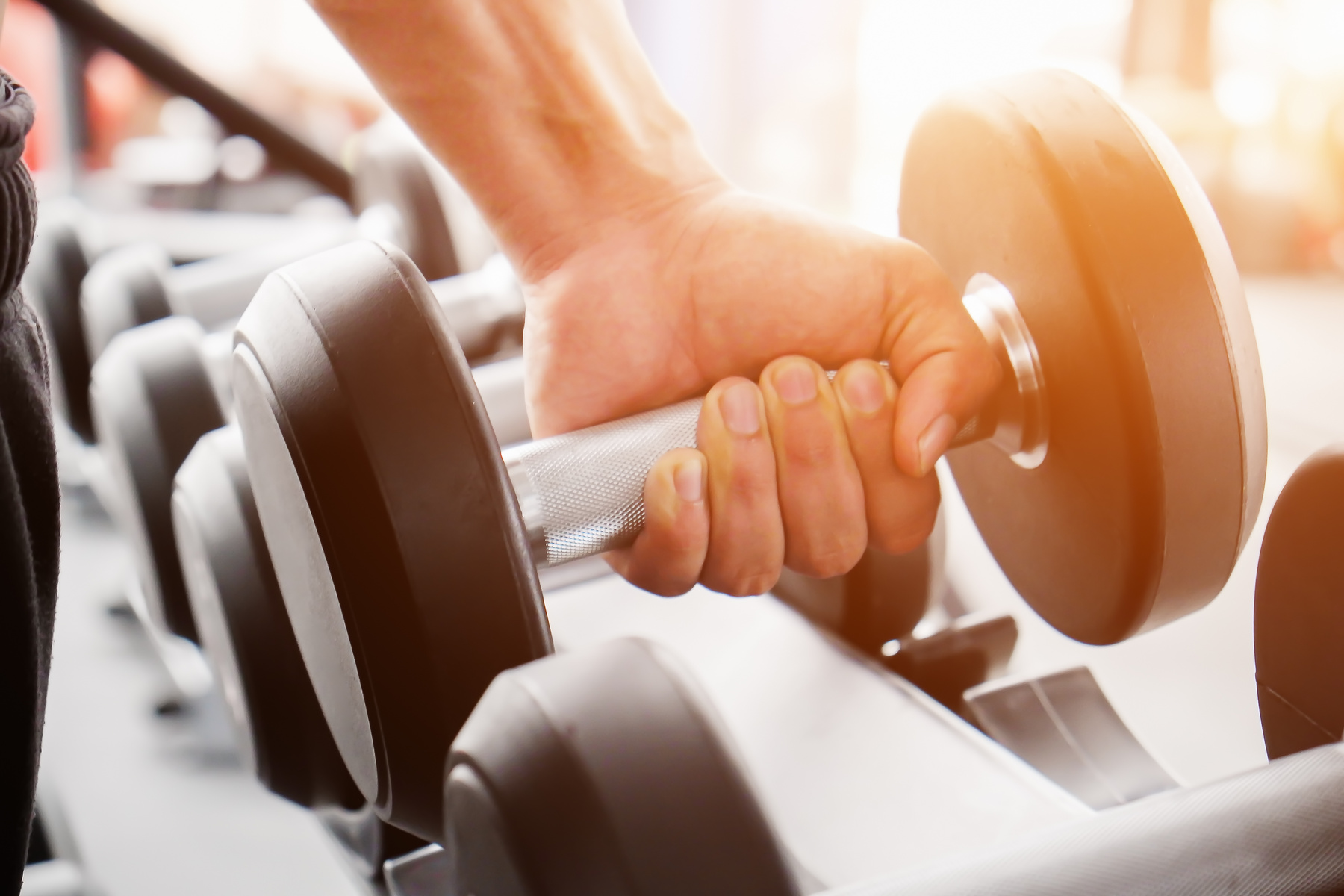 Close up of Man Holding Dumbbell in the Gym